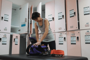 Woman packing a bag in the gym locker room